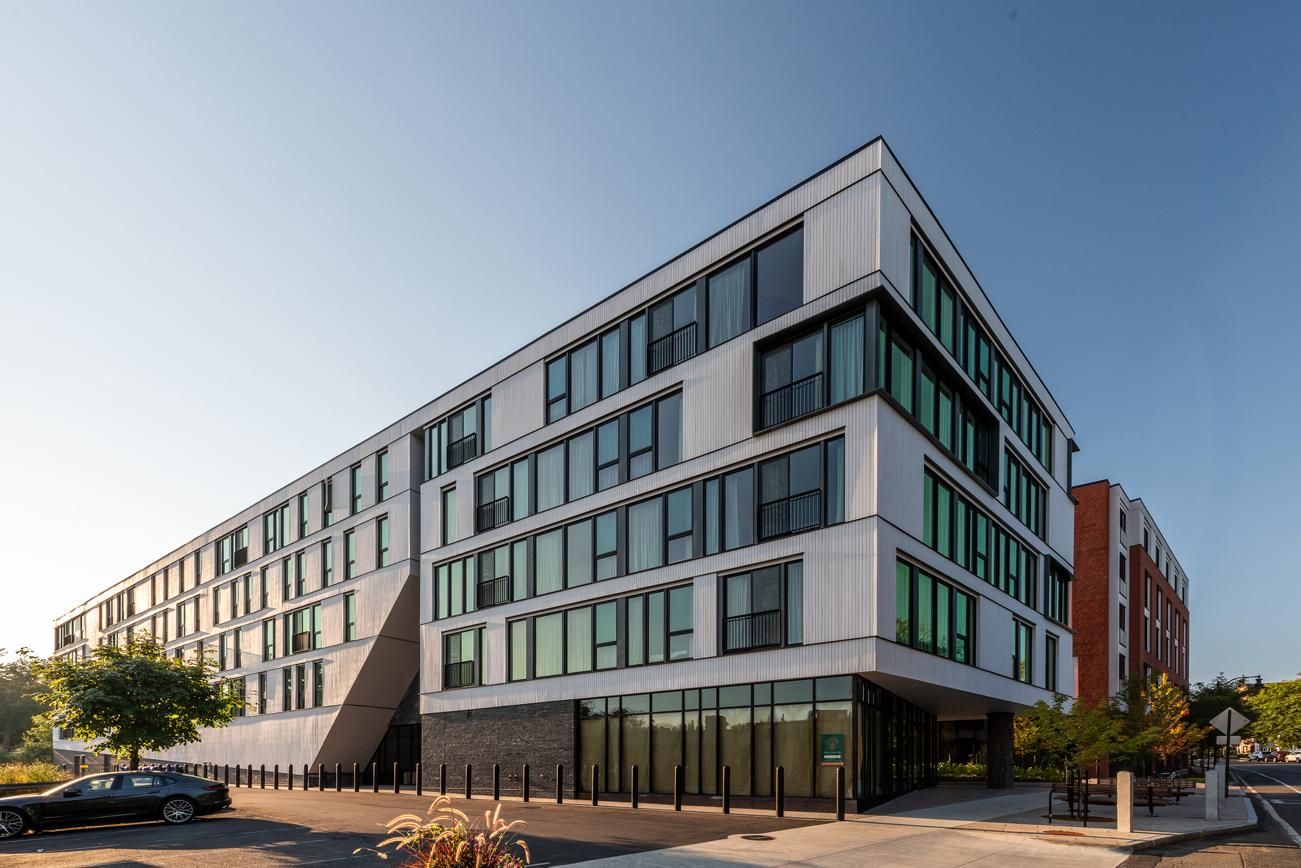 Exterior of Eleven East Pleasant in Amherst, Massachusetts, featuring a modern facade with cedar, zinc, and brick panels.