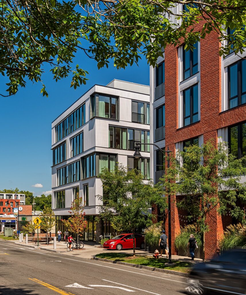 Exterior of Eleven East Pleasant in Amherst, Massachusetts, featuring a modern facade with cedar, zinc, and brick panels.