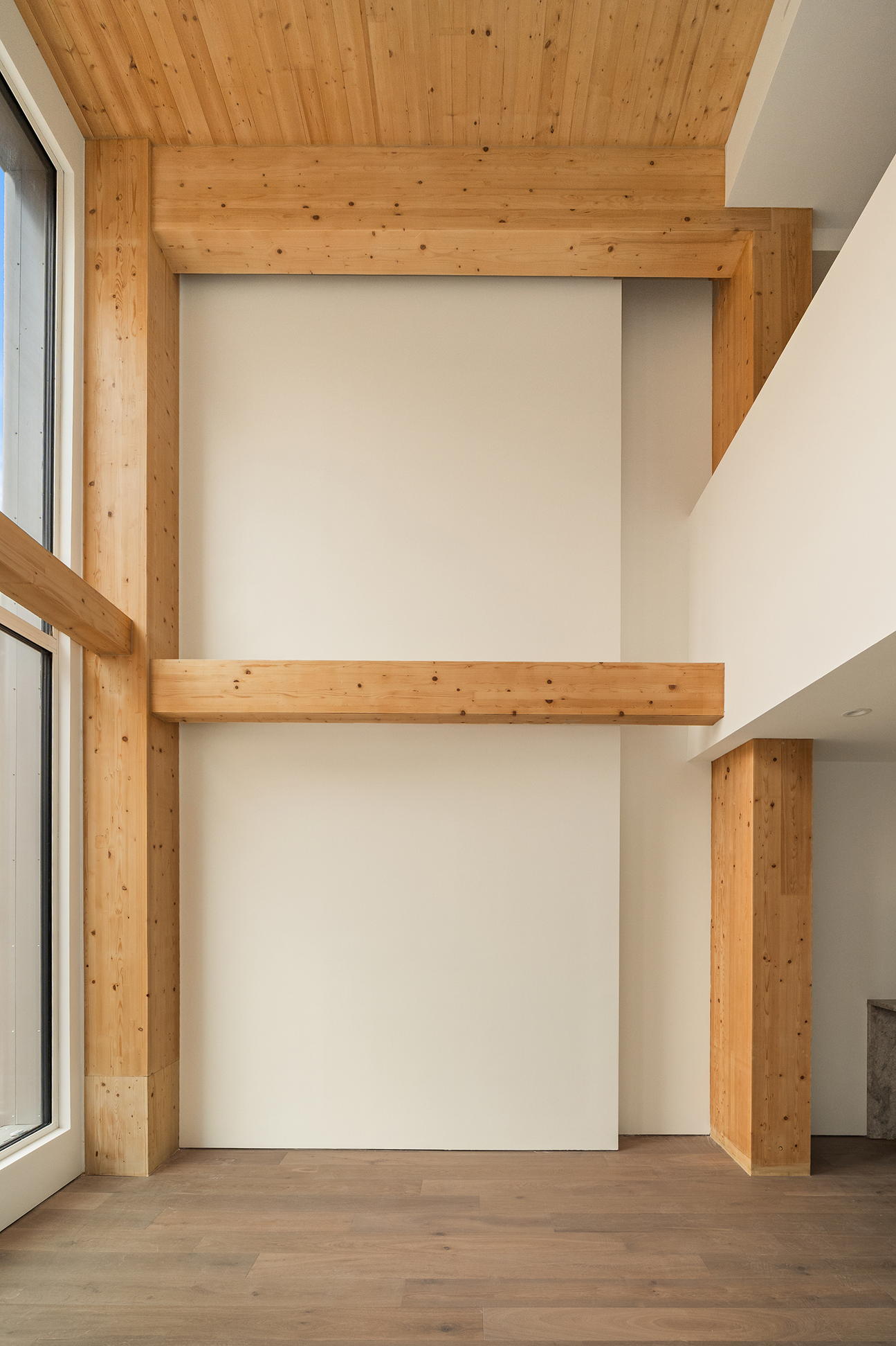 Close-up of exposed glulam beams, columns, and wood ceiling panels inside Timberburg in New York City.